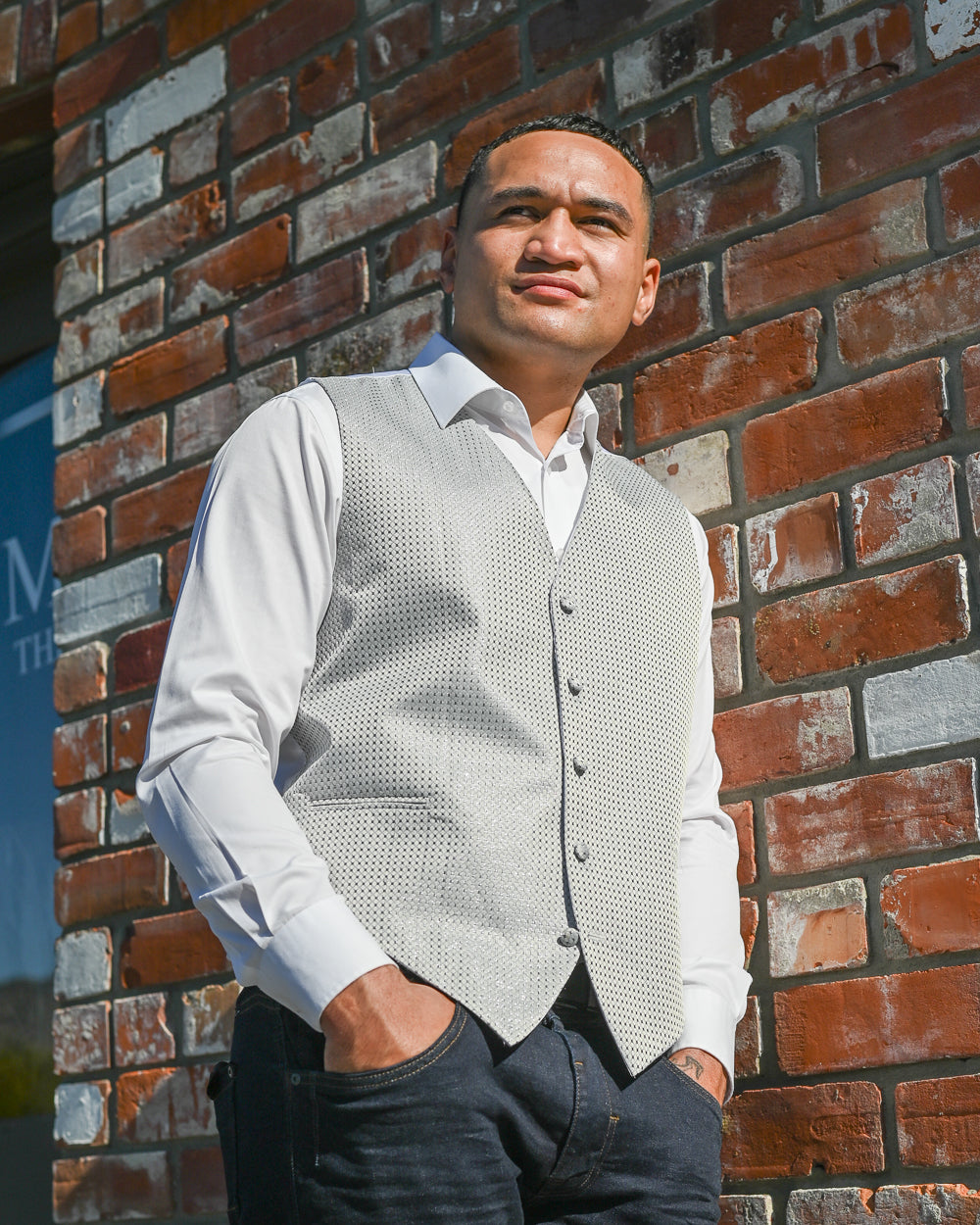 Young man wearing a light grey waistcoat with a white shirt