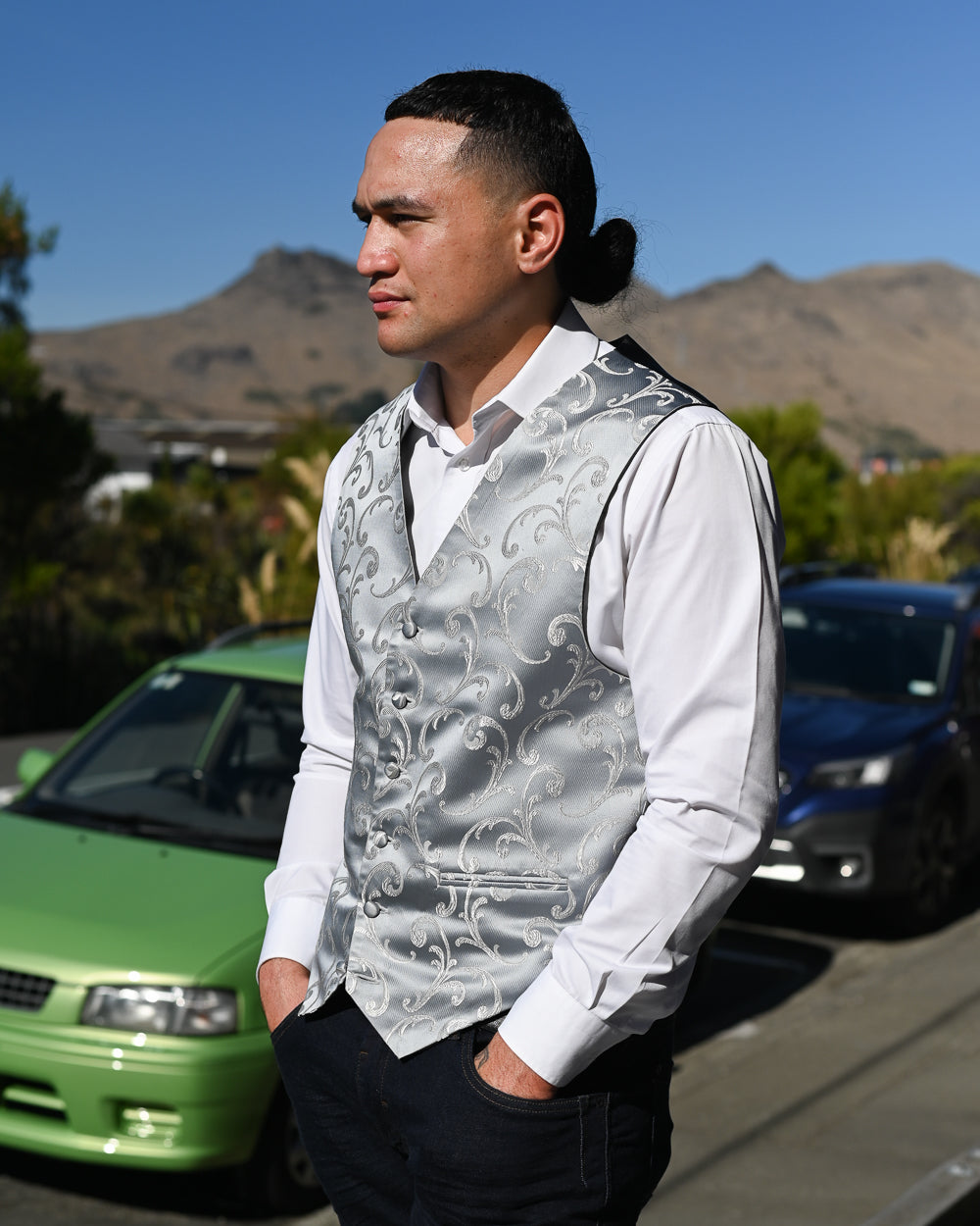 Young Samoan man wearing silver rococo pattern waistcoat