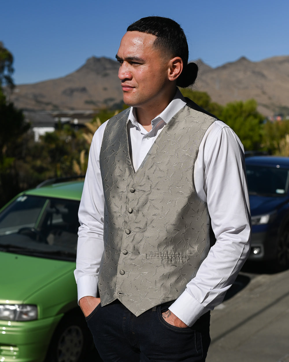 Young man wearing grey waistcoat with white shirt