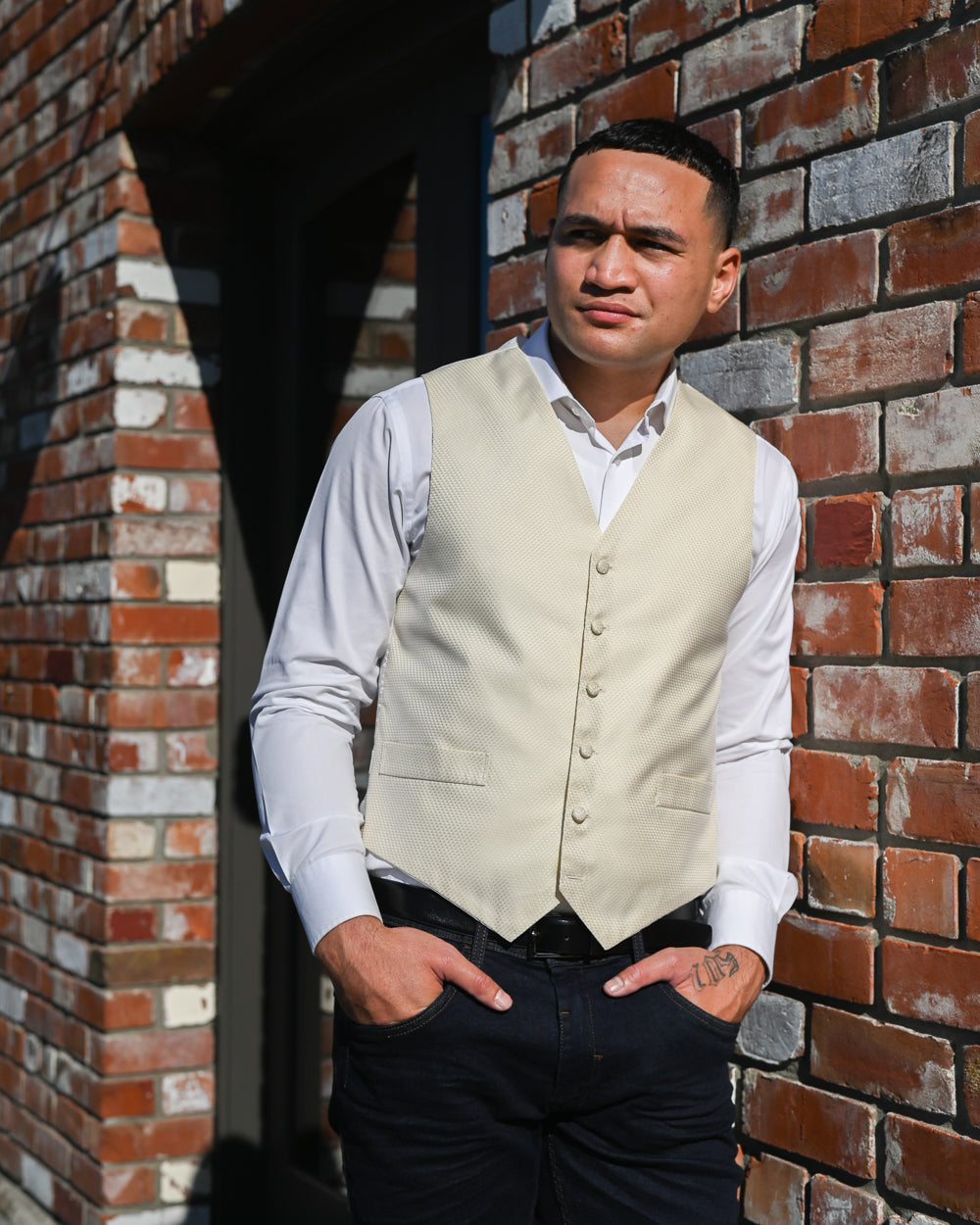 Handsome young Samoan man wearing a textured cream waistcoat with a white shirt