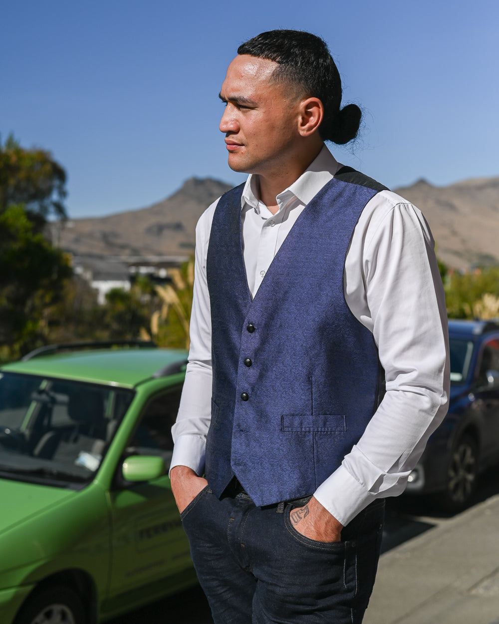 Young man wearing a navy blue textured waistcoat