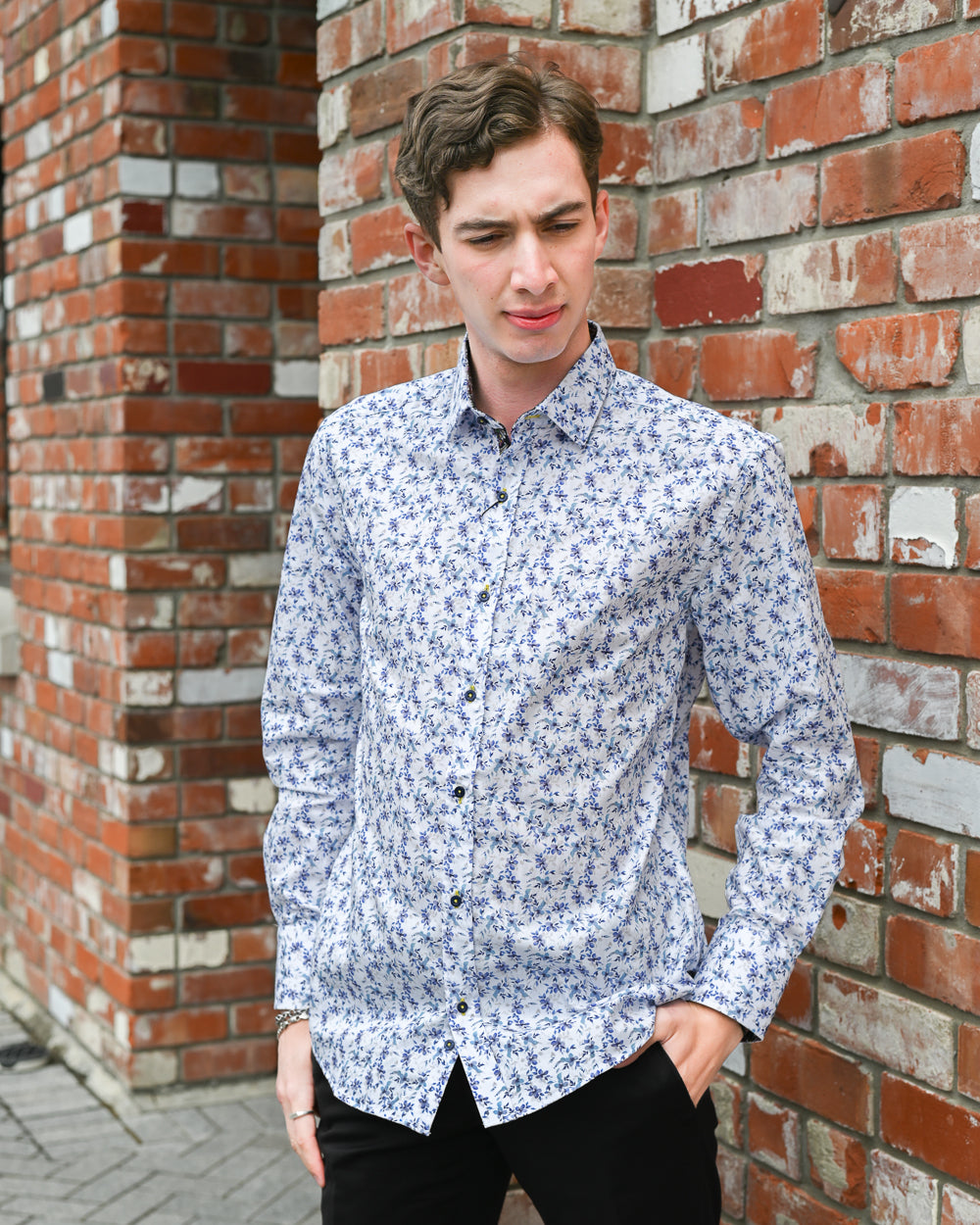 Man wearing a long-sleeve shirt with a blue floral pattern on it by Di Nero