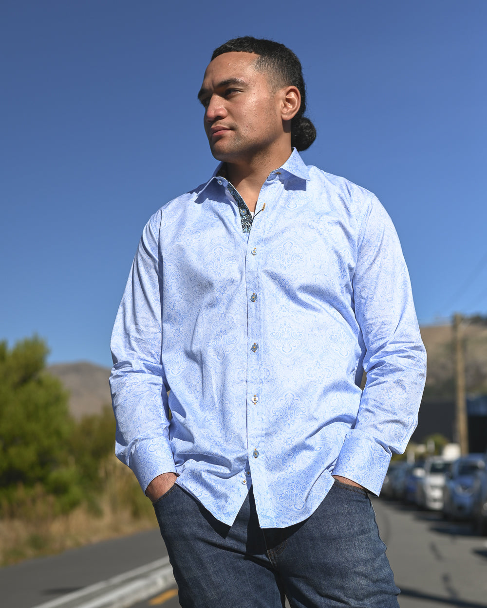 Handsome young Samoan man wearing a pale blue cotton shirt by Franco Negretti