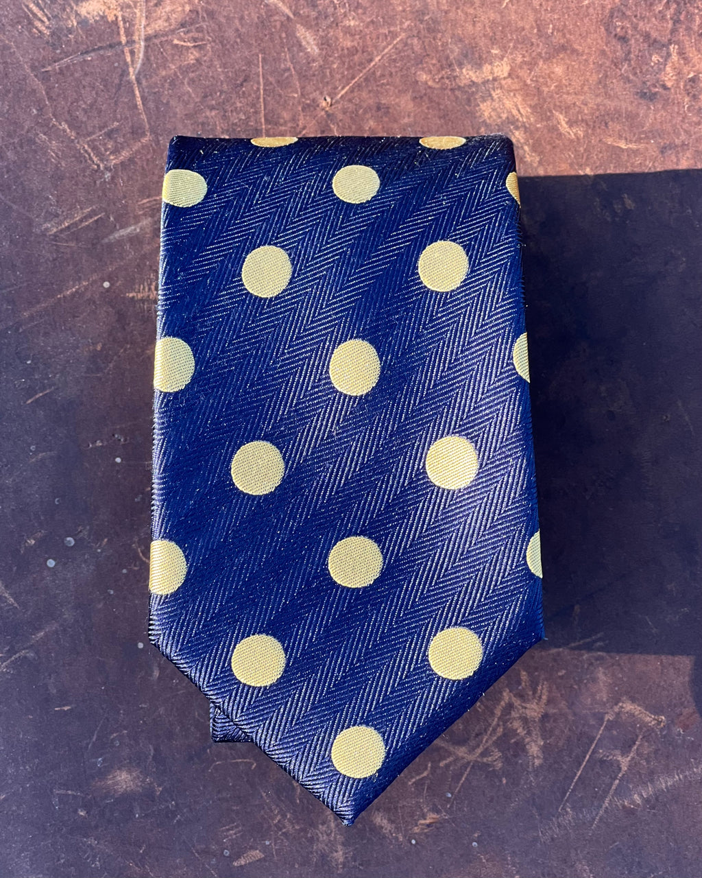 Pure silk tie featuring gold spots on blue background