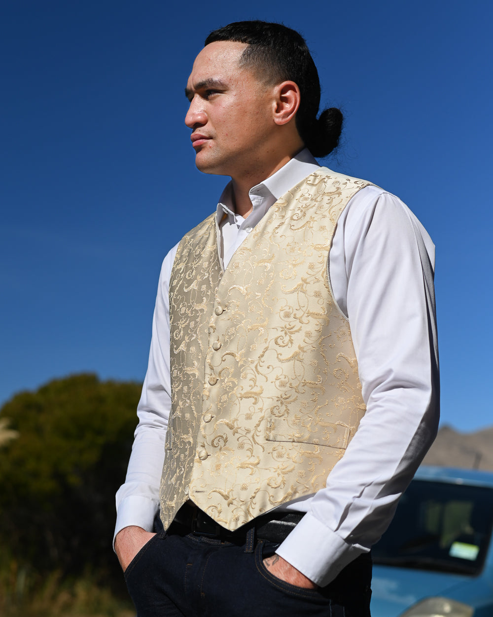 Handsome young man in gold rococo patterned waistcoat