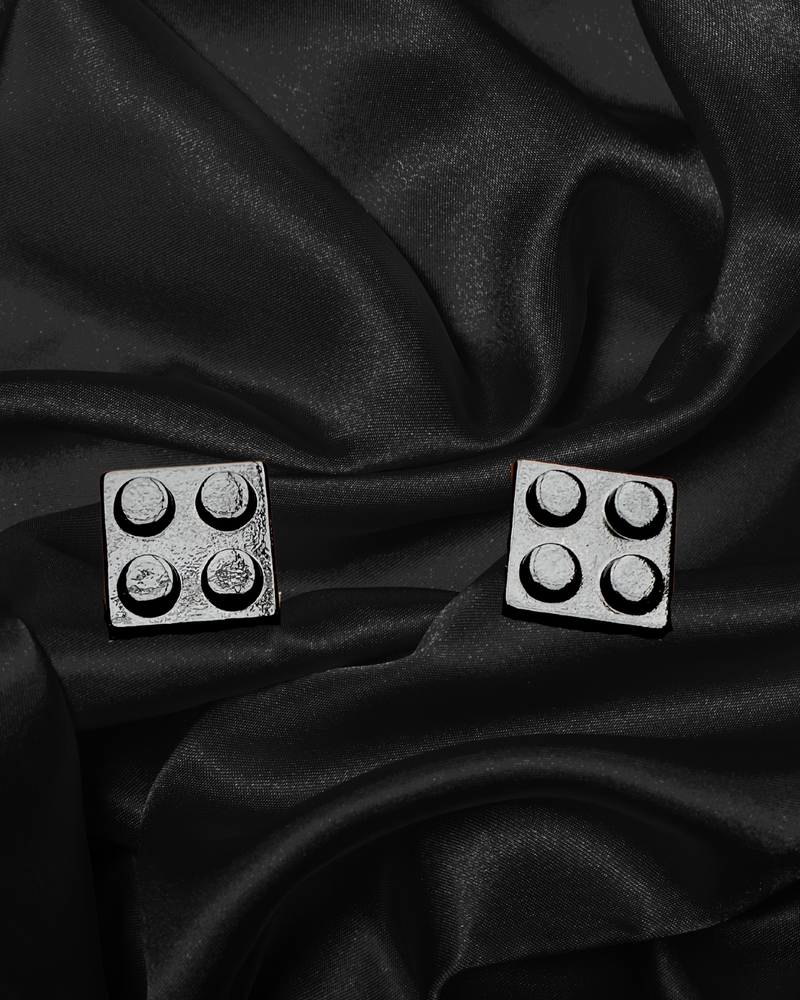Cufflinks that look like small squares of black lego
