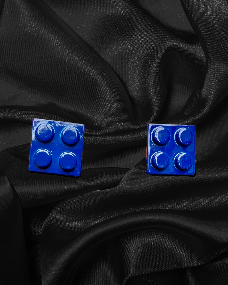 Cufflinks that look like small squares of blue lego