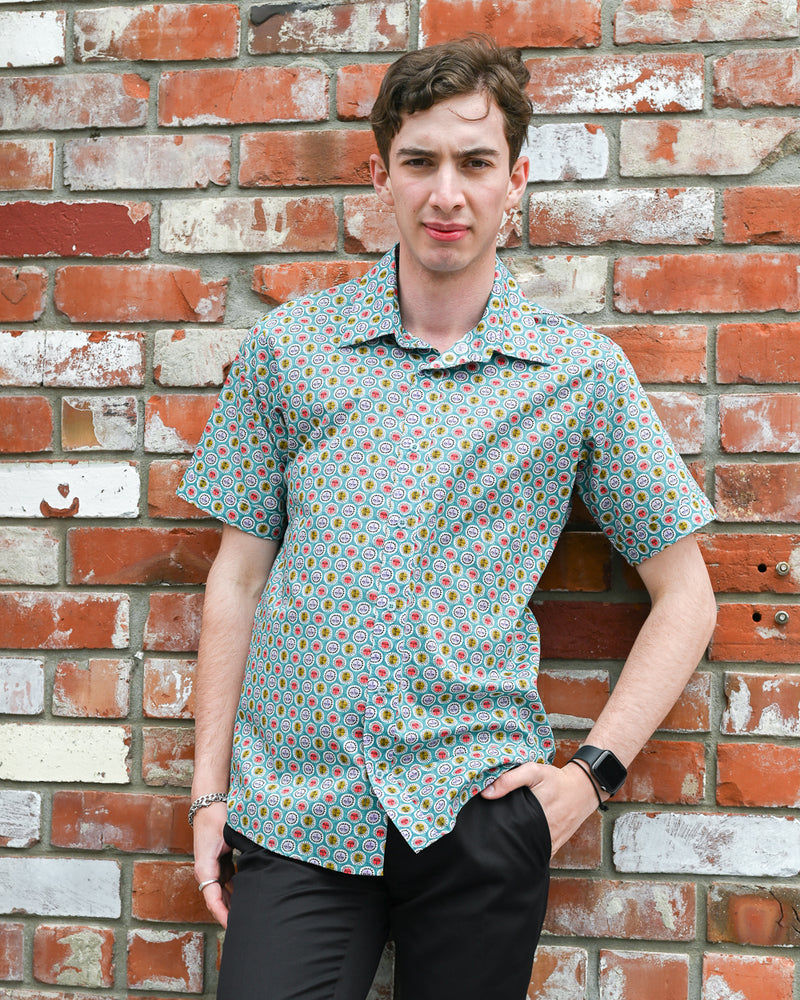 Man wearing a short-sleeve cotton shirt with suns on it by Mr Peacock made in NZ