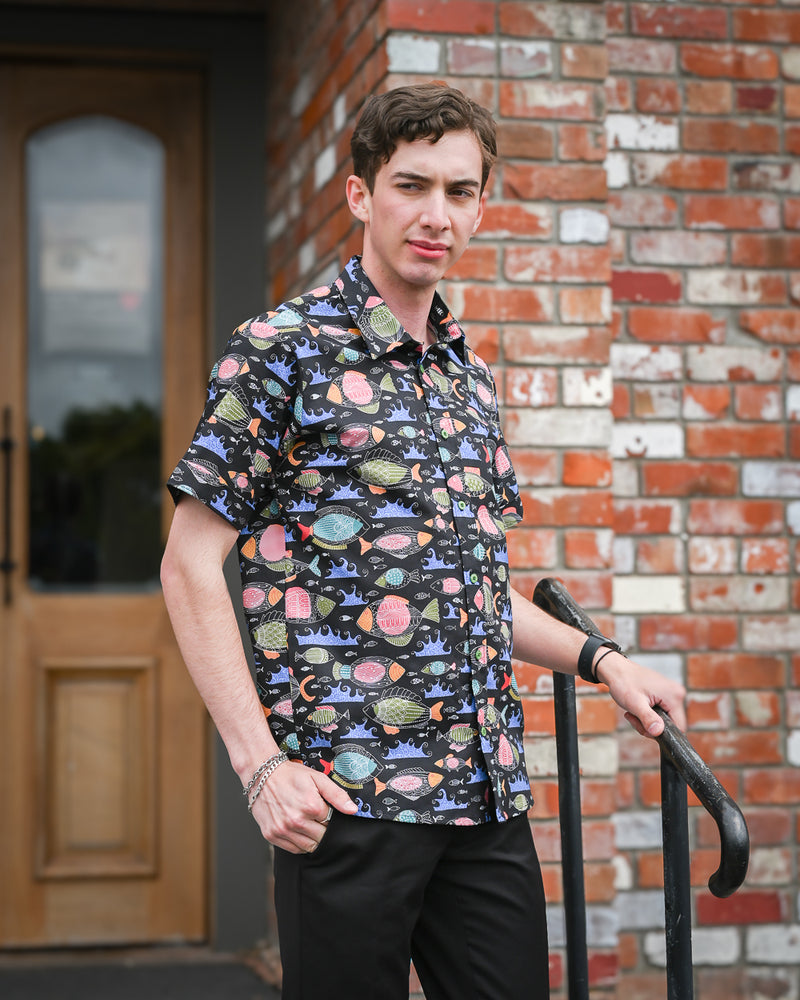 Man wearing a short-sleeve cotton fish print shirt by Mr Peacock made in NZ