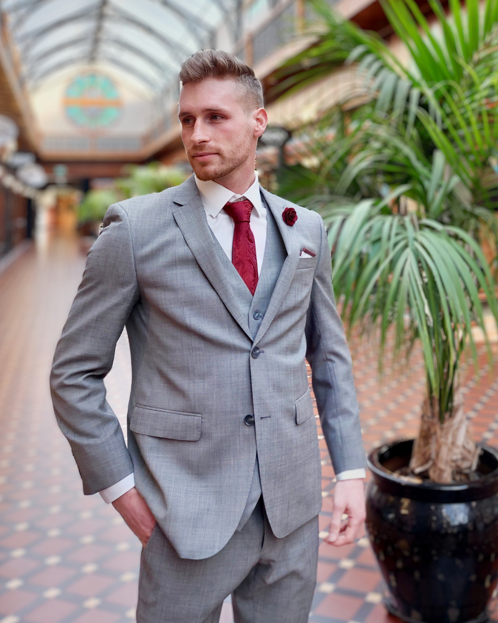 Young blonde man in grey Savile Row three-piece suit