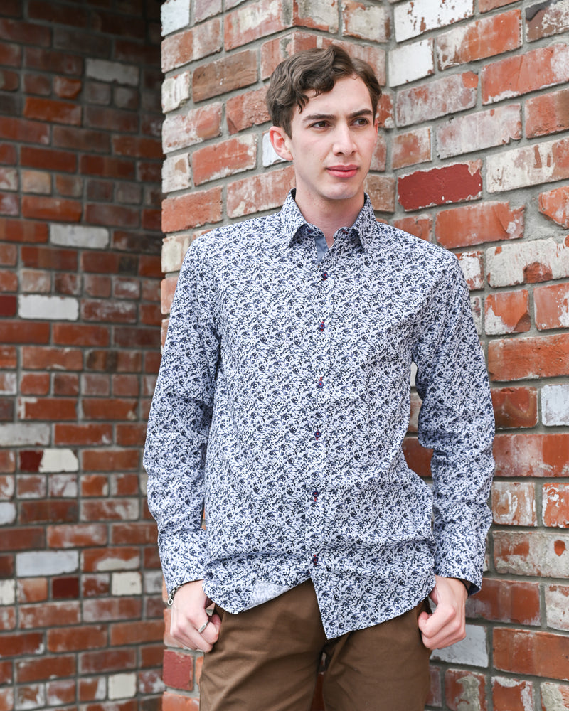 Man wearing a long-sleeve shirt with a blue pattern on it by Di Nero