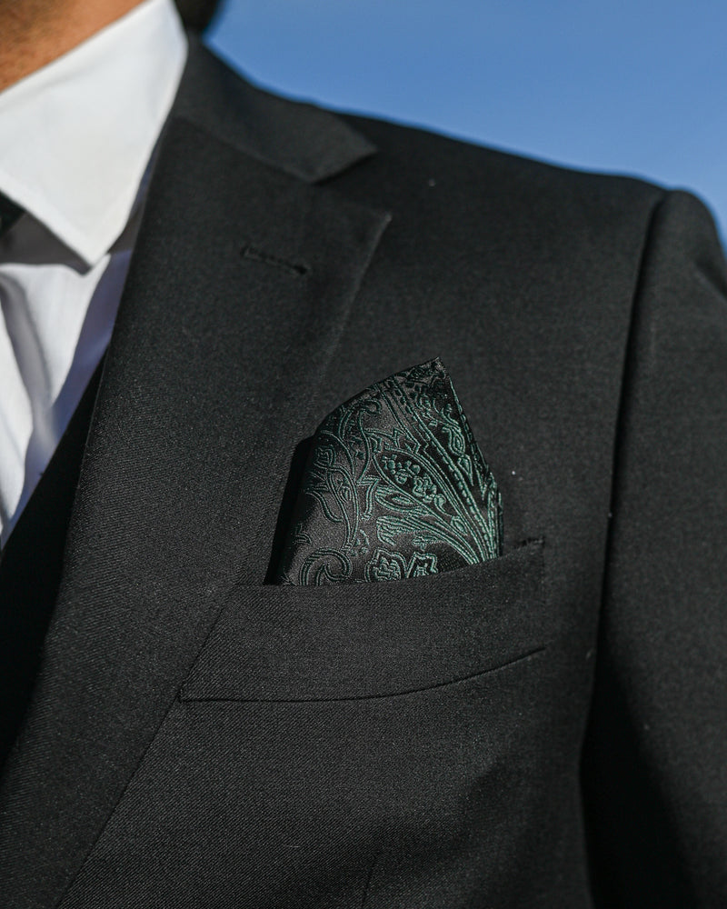 Green paisley pocket square worn with black suit