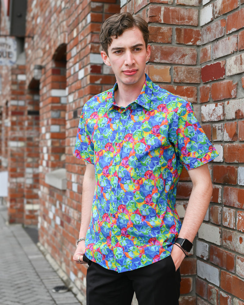 Man wearing a short-sleeve cotton kaleidoscope print shirt by Mr Peacock