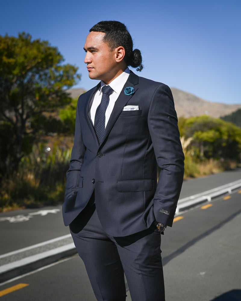 Handsome young Samoan man wearing a Savile Row dark navy suit