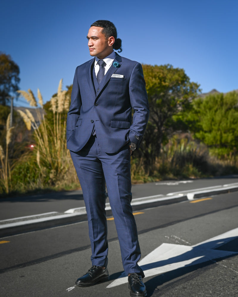 Handsome young man in a navy blue suit by Savile Row