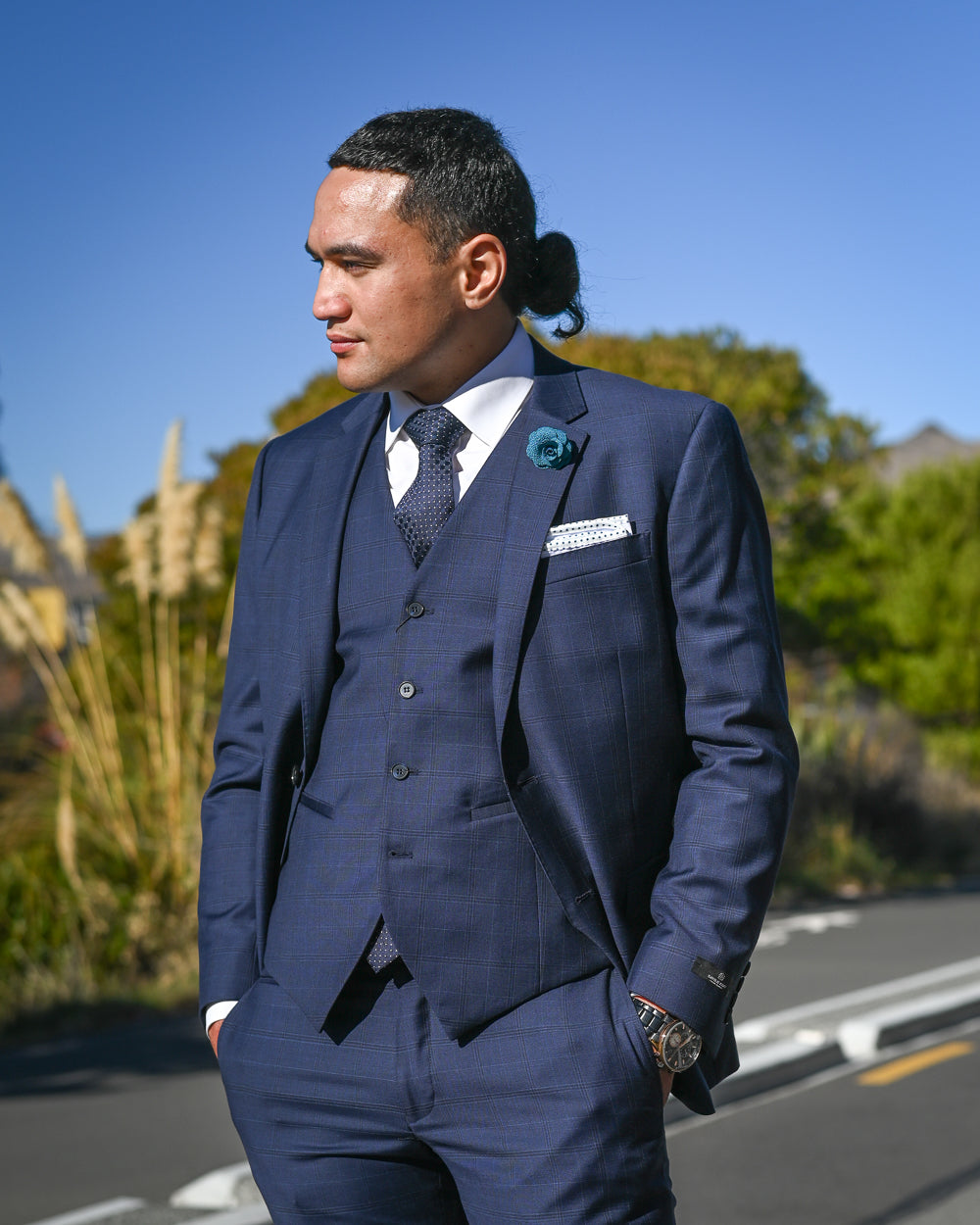 Handsome young man wearing a 3-piece navy merino wool suit by Savile Row