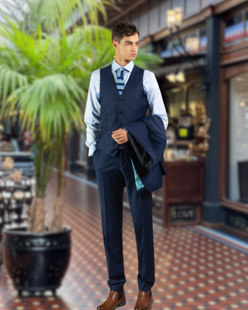 Young man wearing navy suit trousers and waistcoat by Savile Row
