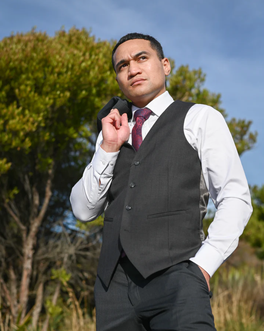 Young man wearing charcoal Savile Row Waistcoat with white shirt and crimson tie