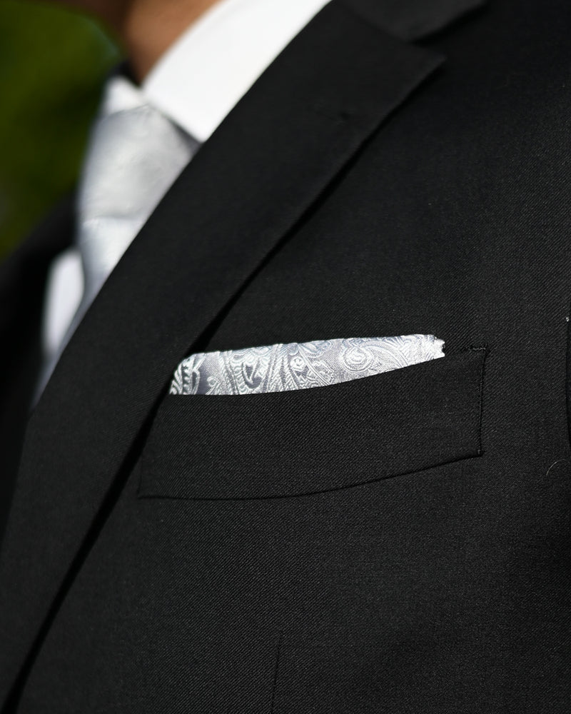 Silver paisley pocket square worn with a black suit