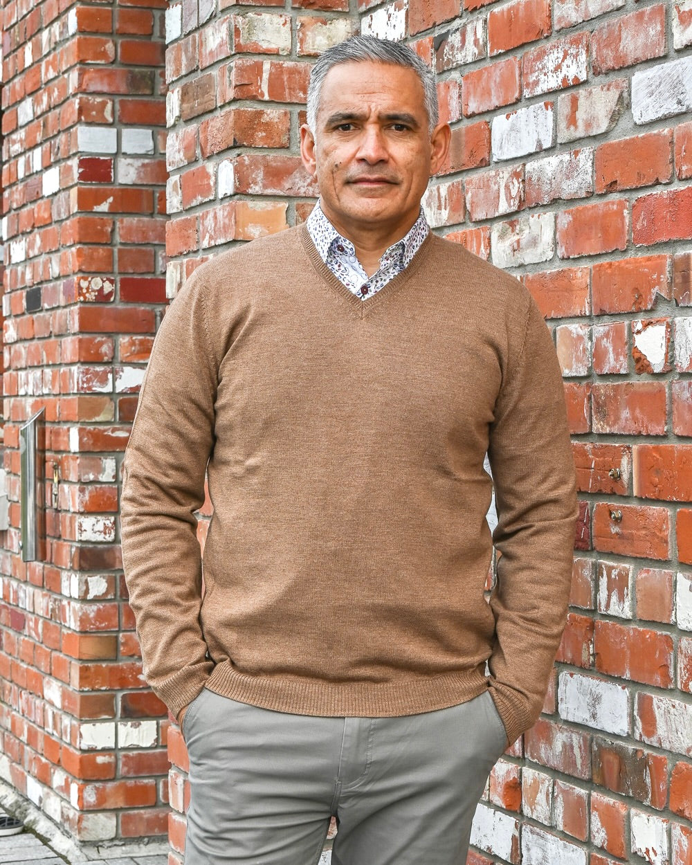 Middle-aged man wearing camel-coloured merino wool v-neck jumper by Silverdale