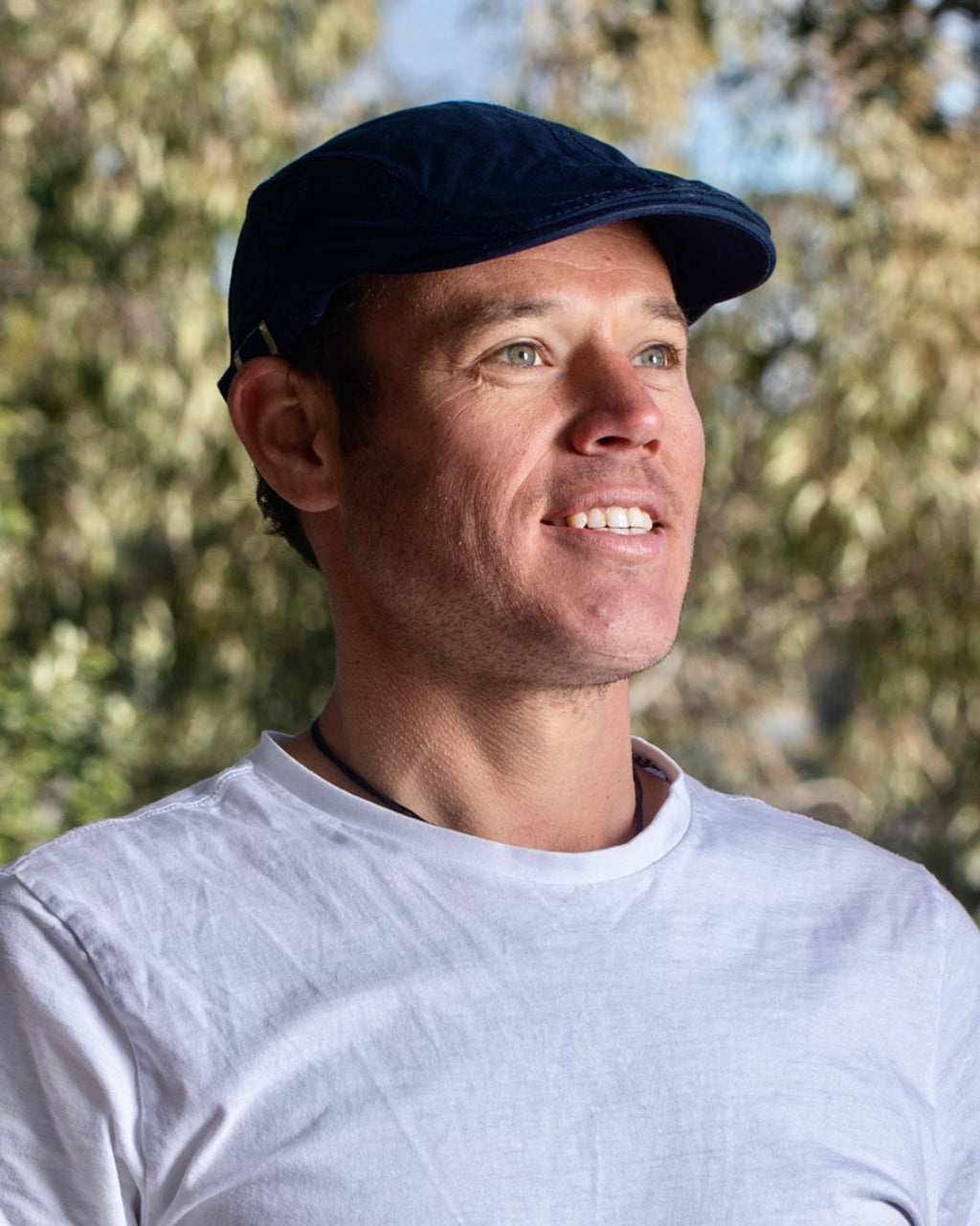 Man wearing navy blue cheese cutter cap by Electric Pukeko