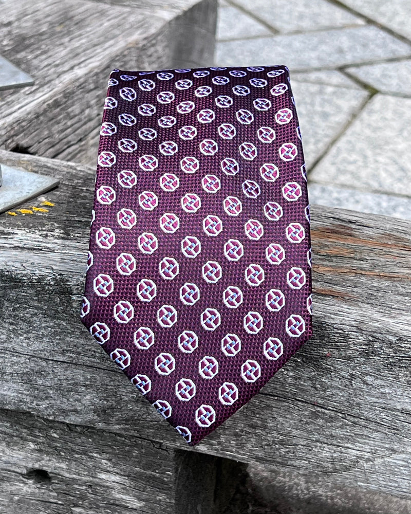 Pure silk tie with abstract circle motifs on burgundy background