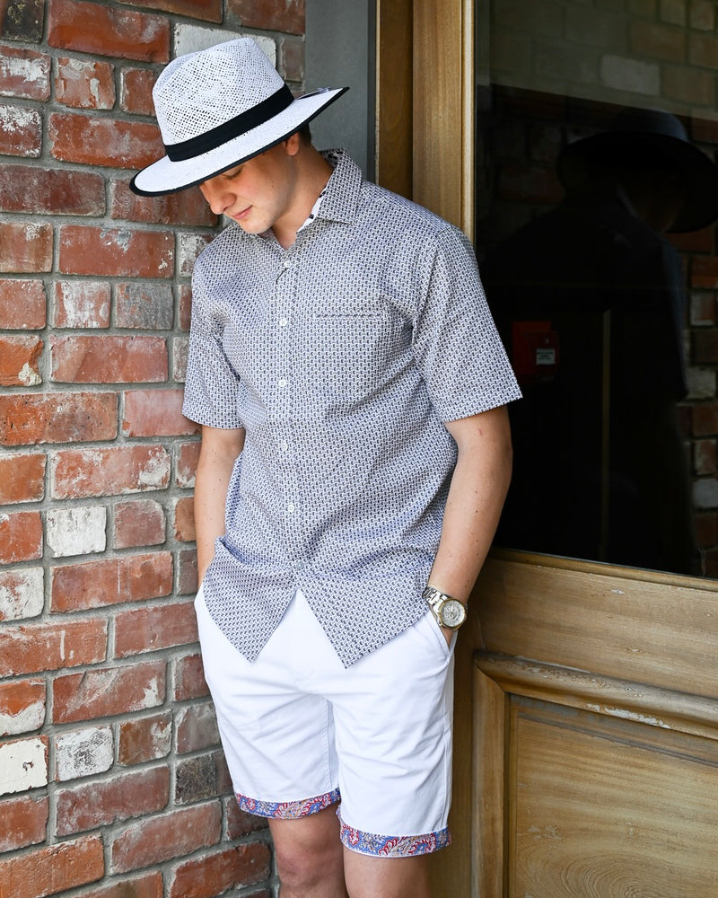 White Havana Shorts by Berlin with contrasting floral cuffs worn with a short-sleeve shirt and a white hat